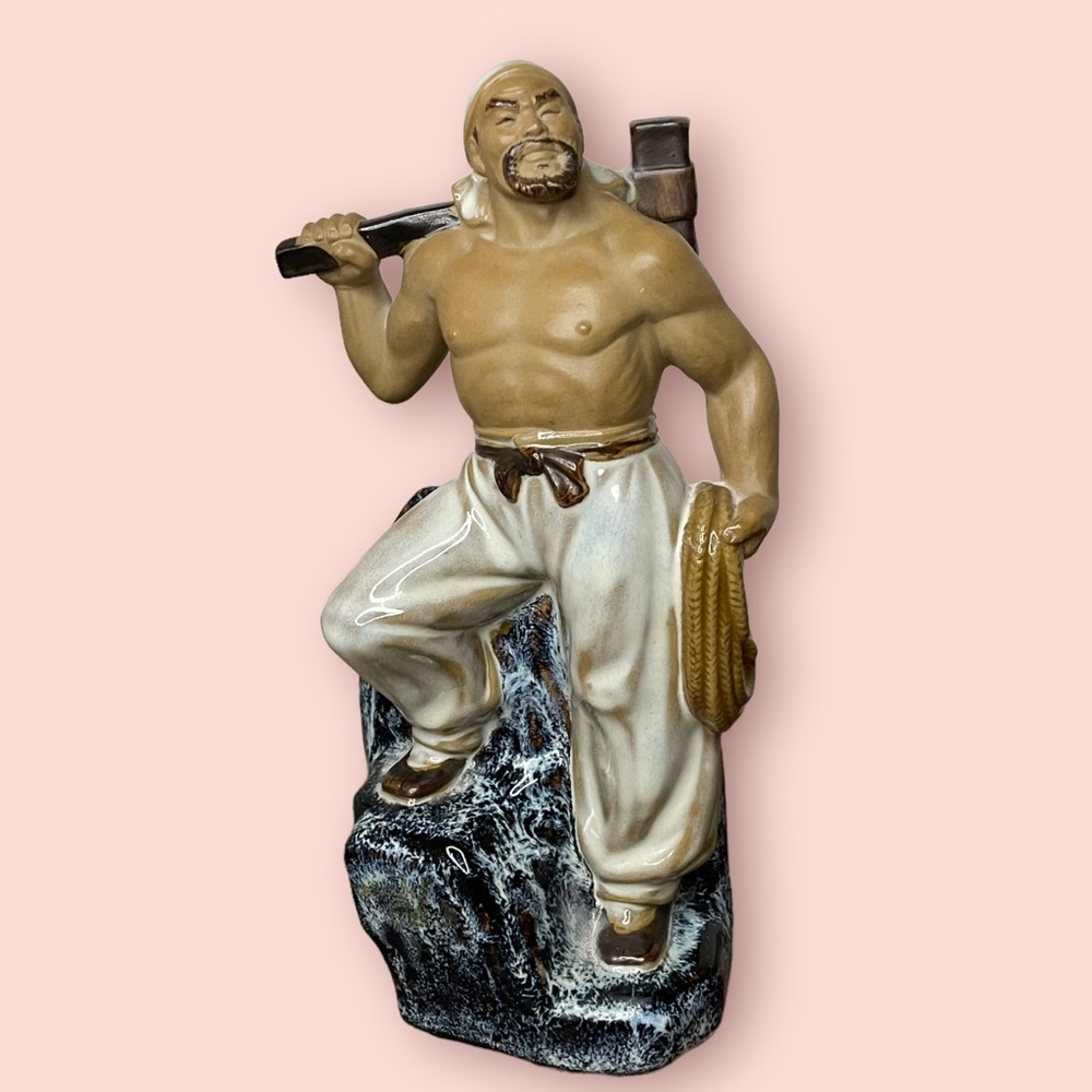 Figurine Man with Rope and Axe Standing on Rock